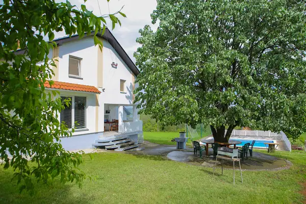 Villa garden with a table for gatherings under the tree