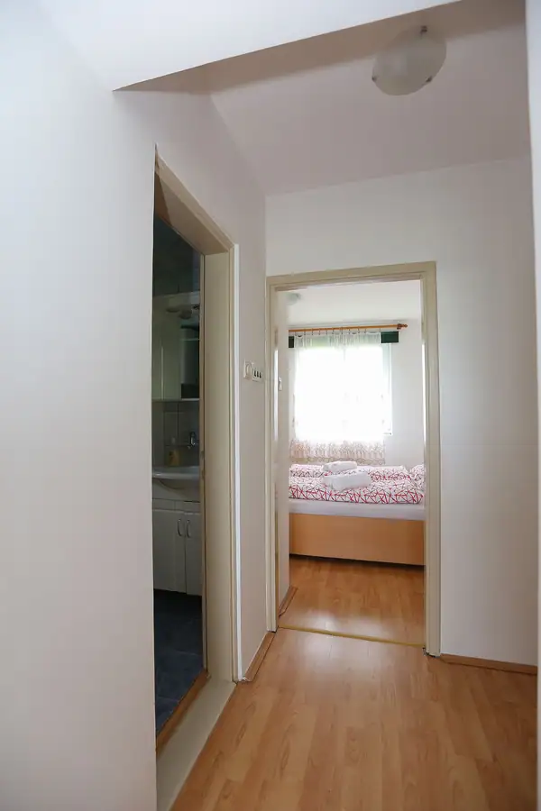 Hallway with a view into a bedroom