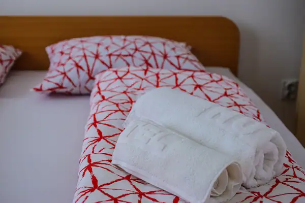 Neatly made bed with towels