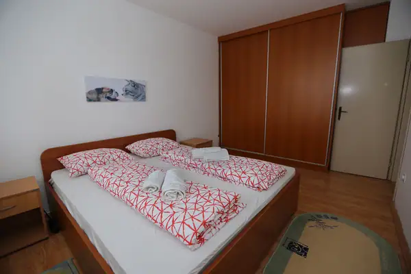 Bedroom with a large wardrobe and a double bed