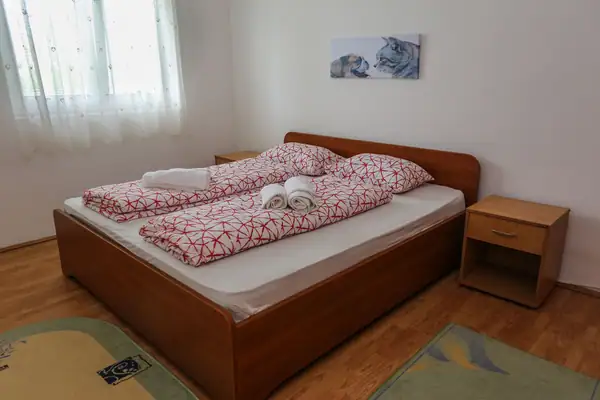 Double bed with red and white bed linen