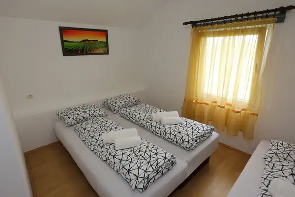 Beds with black and white linen by the window