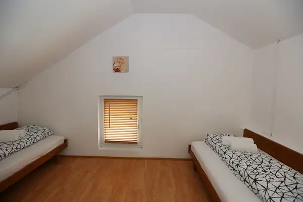 Sloped-ceiling room with a bed