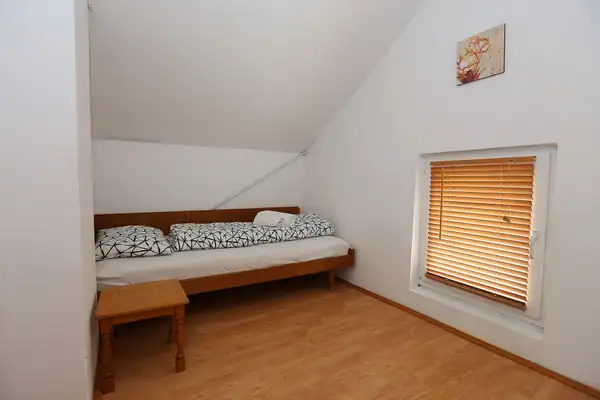 Upstairs room with beds and a small table