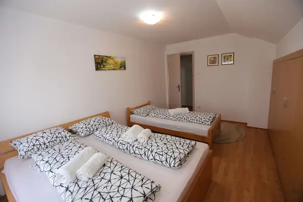 Room with several beds and towels