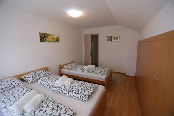 Guest room with several beds and towels