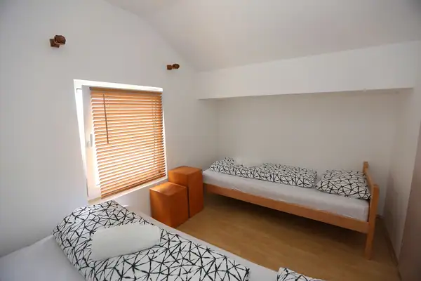 Room with beds and wooden side tables
